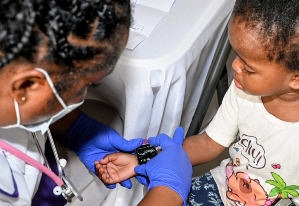 Volunteer Nurse check vitals of a youngster at the Mission health fair 9/6/26 at Barbican Church in St Andrew Jamaica.